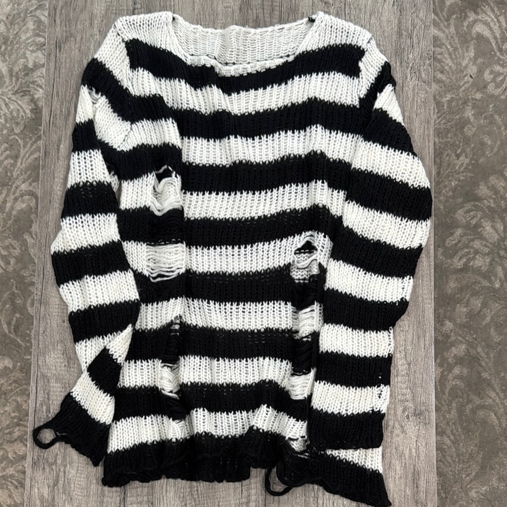 Women’s baggy black and white distressed sweater